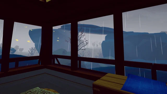 Rain falls outside the windows of a furnished wooden cabin