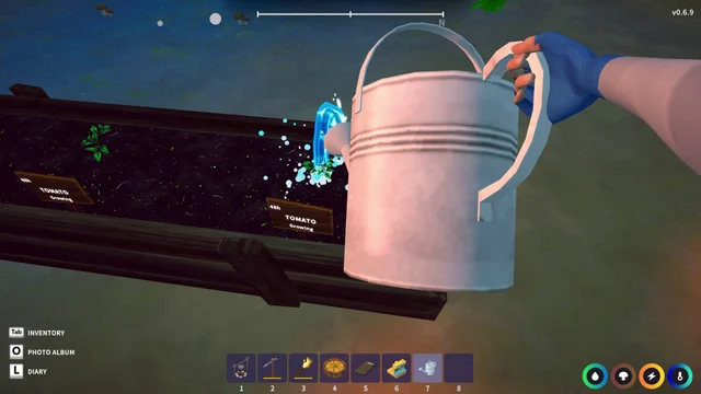 Watering a planted garden bed with a watering can