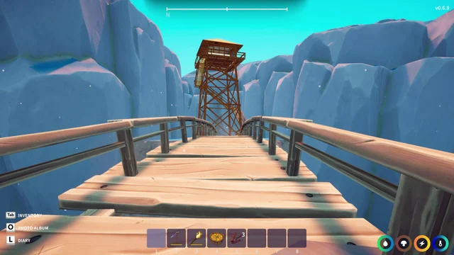 A wooden bridge leads toward a watchtower below the cliffs